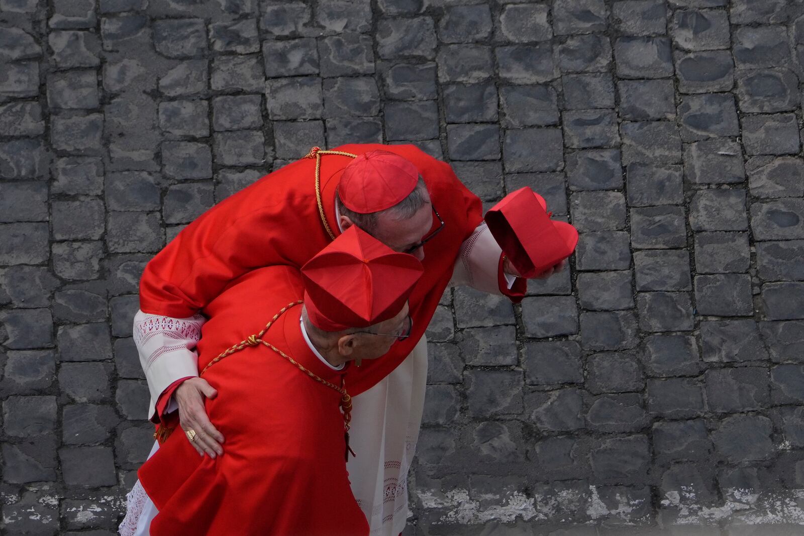 Prelates walk at St. Peter's Square ahead of the arrival of the body of Pope Francis, who will lie in state at St. Peter's Basilica for three days, at the Vatican, Wednesday, April 23, 2025. (AP Photo/Gregorio Borgia)