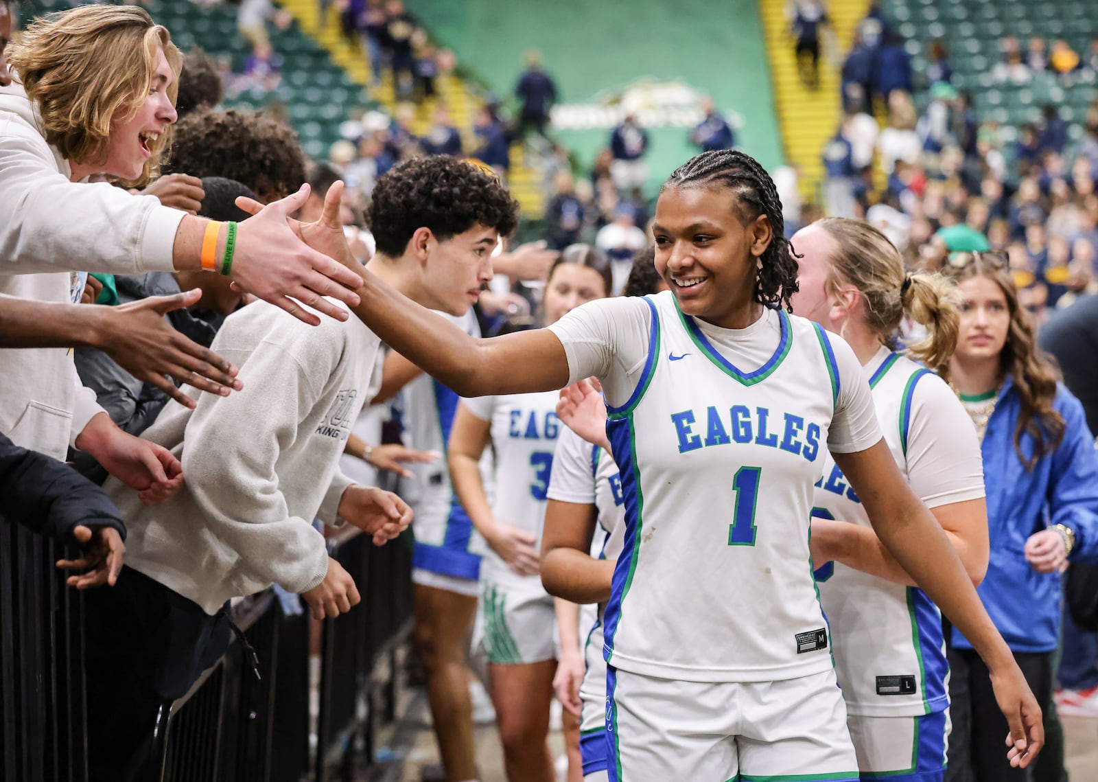 Chaminade-Julienne freshman guard Ja'Kyiah Cook shakes hands with fans following a 62-57 win over Copley in a Division III state semifinal on Thursday, March 12 at Ervin J. Nutter Center in Fairborn. Cook led the squad with 16 points and had eight rebounds, four assists and four steals. BRYANT BILLING / STAFF
