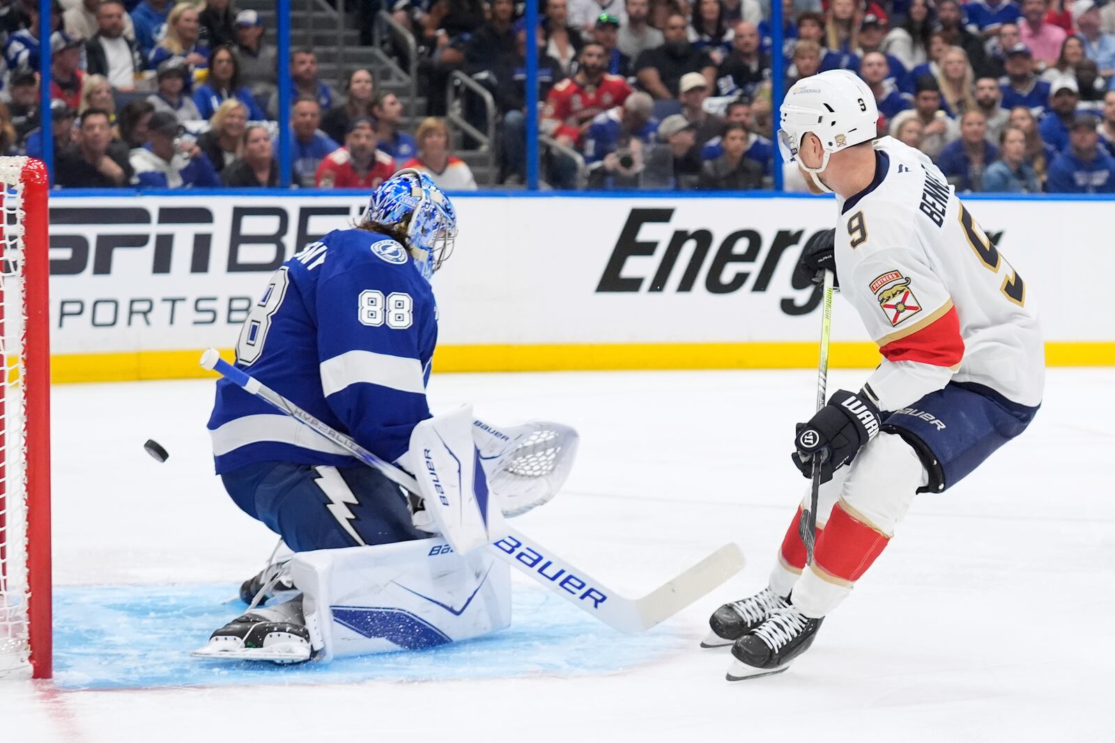 Florida Panthers center Sam Bennett (9) watches his deflection get past Tampa Bay Lightning goaltender Andrei Vasilevskiy (88) for a goal during the first period in Game 1 of an NHL hockey Stanley Cup first-round playoff series, Tuesday, April 22, 2025, in Tampa, Fla. (AP Photo/Chris O'Meara)