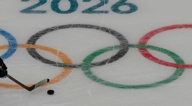 A France men's ice hockey player moves the puck during a training session ahead of the 2026 Winter Olympics in Milan, Italy, Tuesday, Feb. 3, 2026. (AP Photo/Hassan Ammar)
