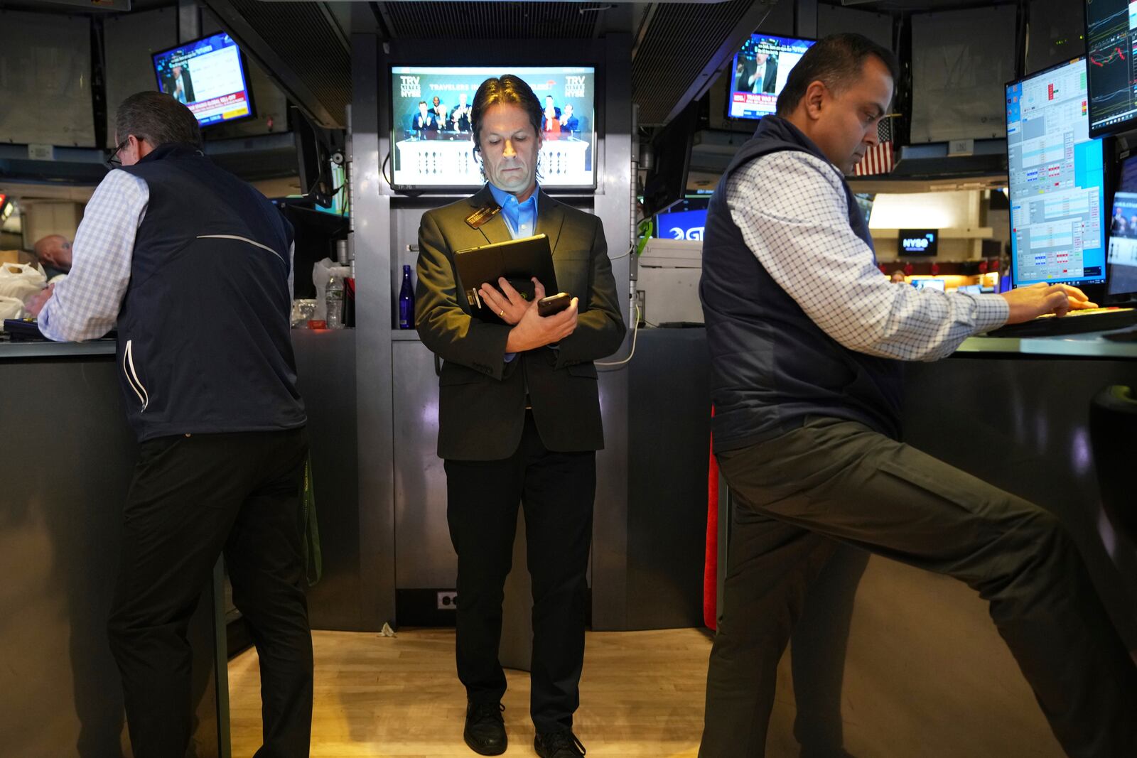 Traders work on the floor at the New York Stock Exchange in New York, Monday, April 7, 2025. (AP Photo/Seth Wenig)