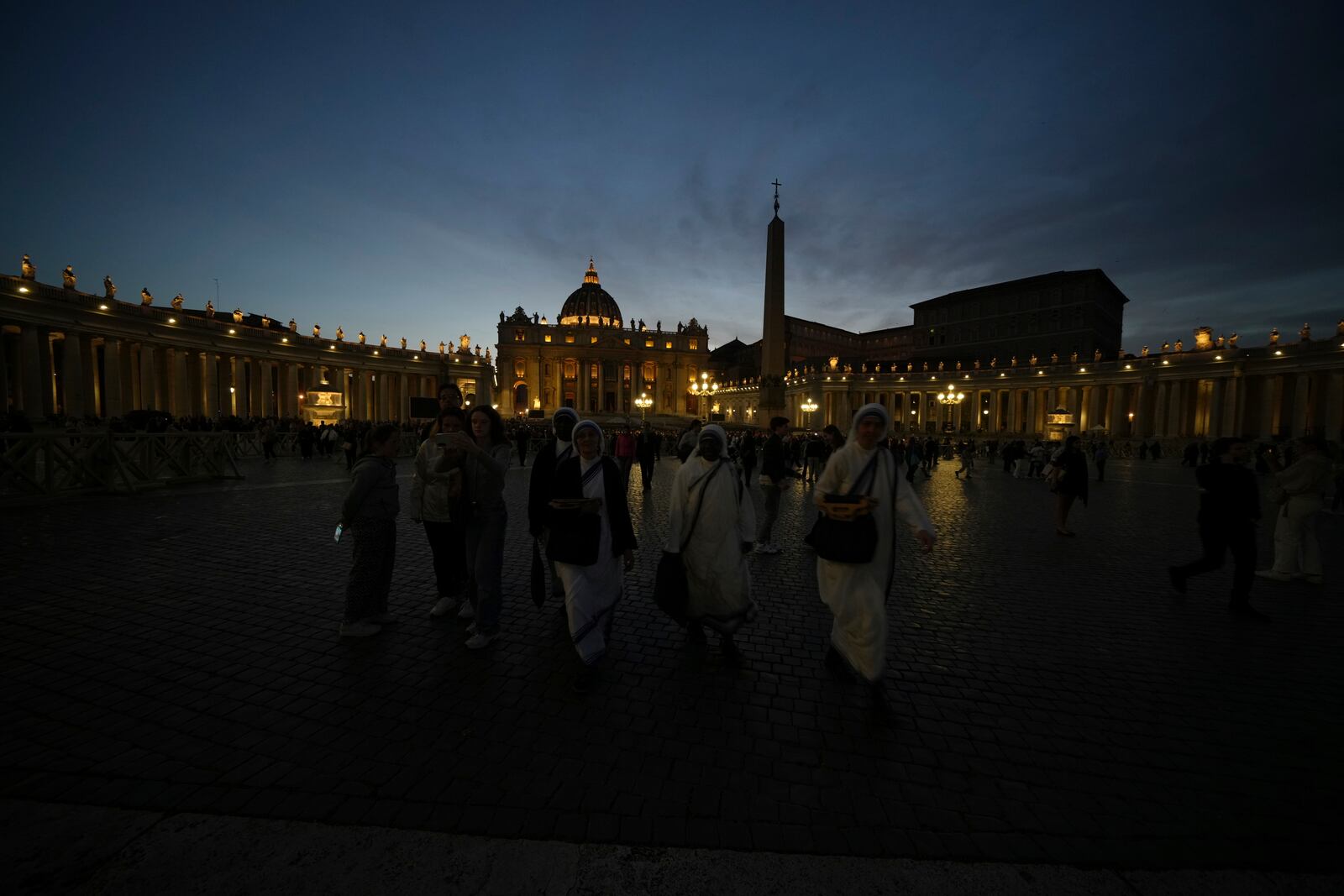 Nuns leave after a rosary prayer for the late Pope Francis, in St. Peter's Square at the Vatican, Monday April 21, 2025. (AP Photo/Alessandra Tarantino)