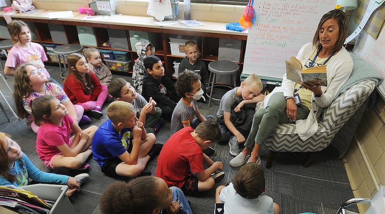 First-grade teacher Angie Beal reads to her class at Oakview Elementary in Kettering. MARSHALL GORBY\STAFF