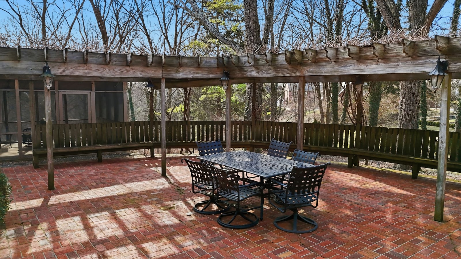 The back of the home features a brick paver patio with wood pergola and built in benches. CONTRIBUTED
