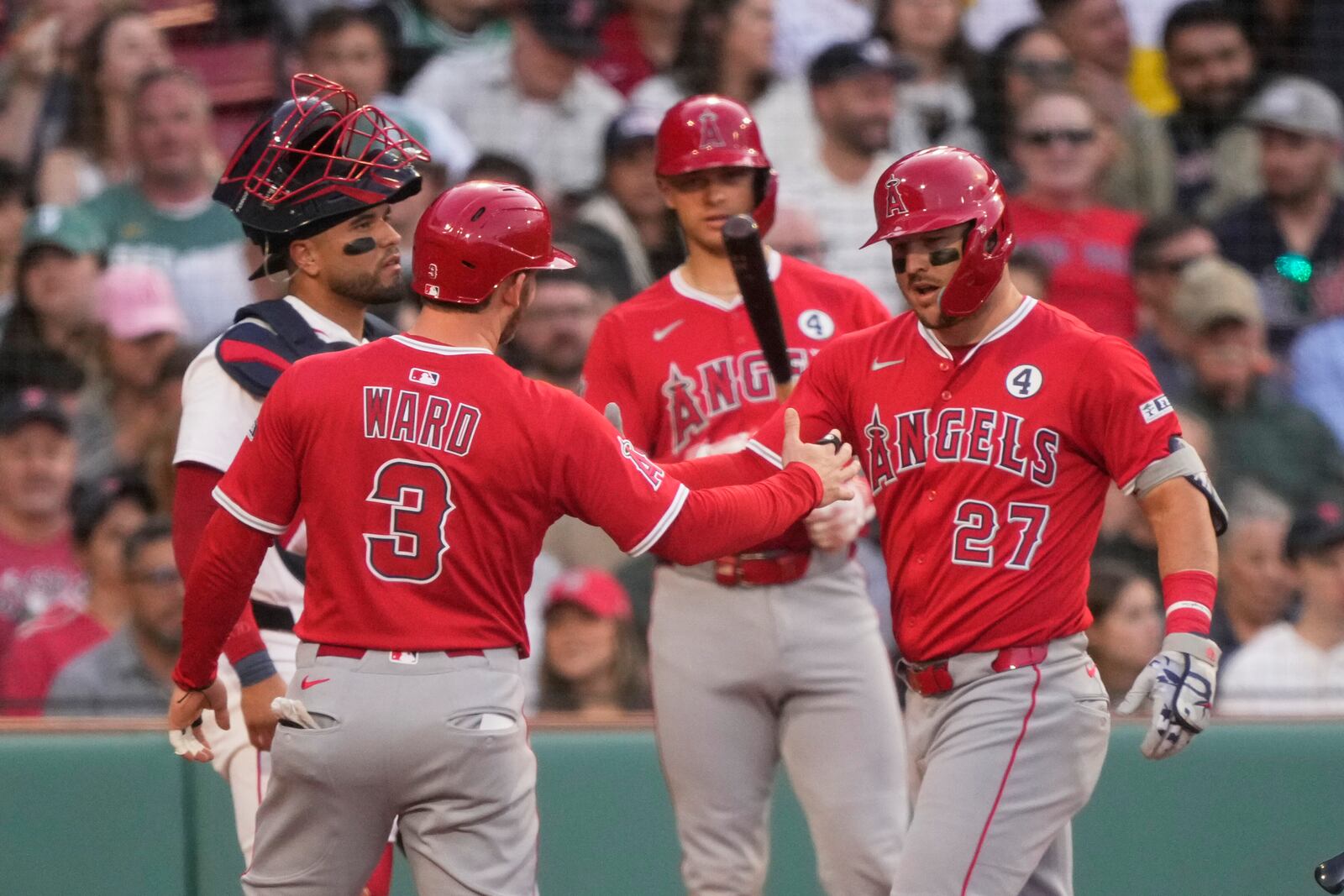 Los Angeles Angels designated hitter Mike Trout (27) is congratulated after a first inning home run in a baseball game against the Boston Red Sox, Monday, June 2, 2025, in Boston. (AP Photo/Robert F. Bukaty)