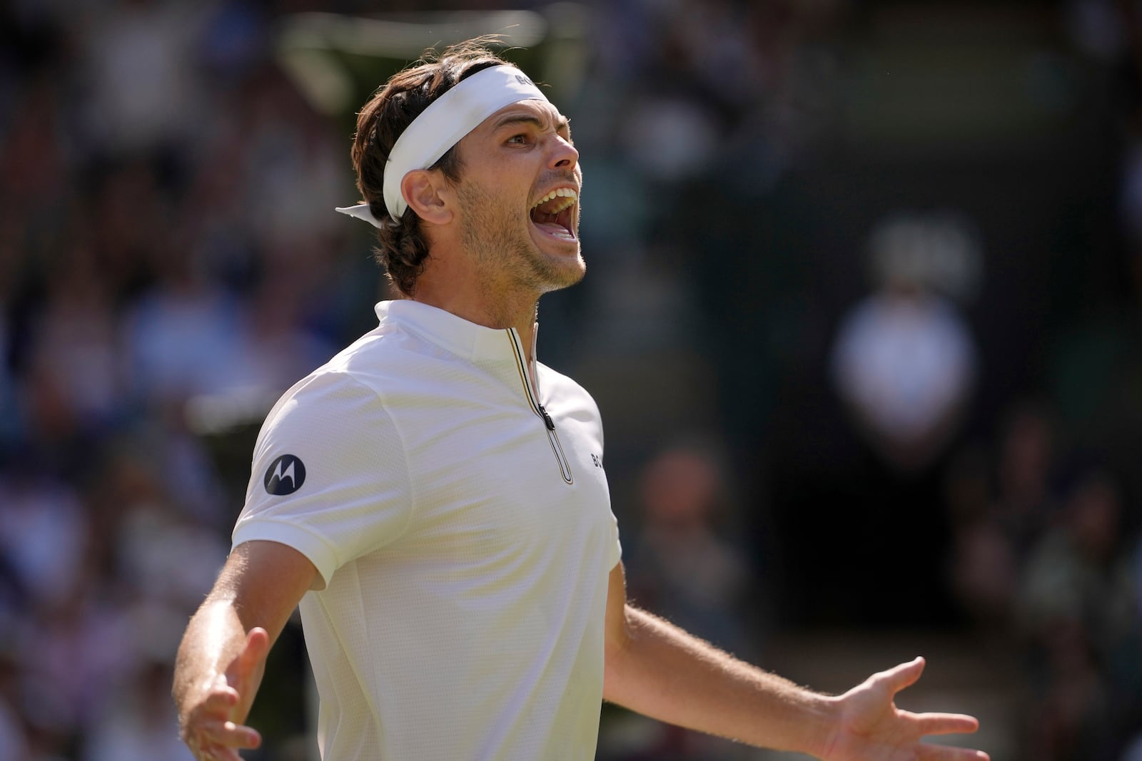 Taylor Fritz of the U.S. celebrates winning the men's singles quarter final match against Karen Khachanov of Russia at the Wimbledon Tennis Championships in London, Tuesday, July 8, 2025.(AP Photo/Kin Cheung)
