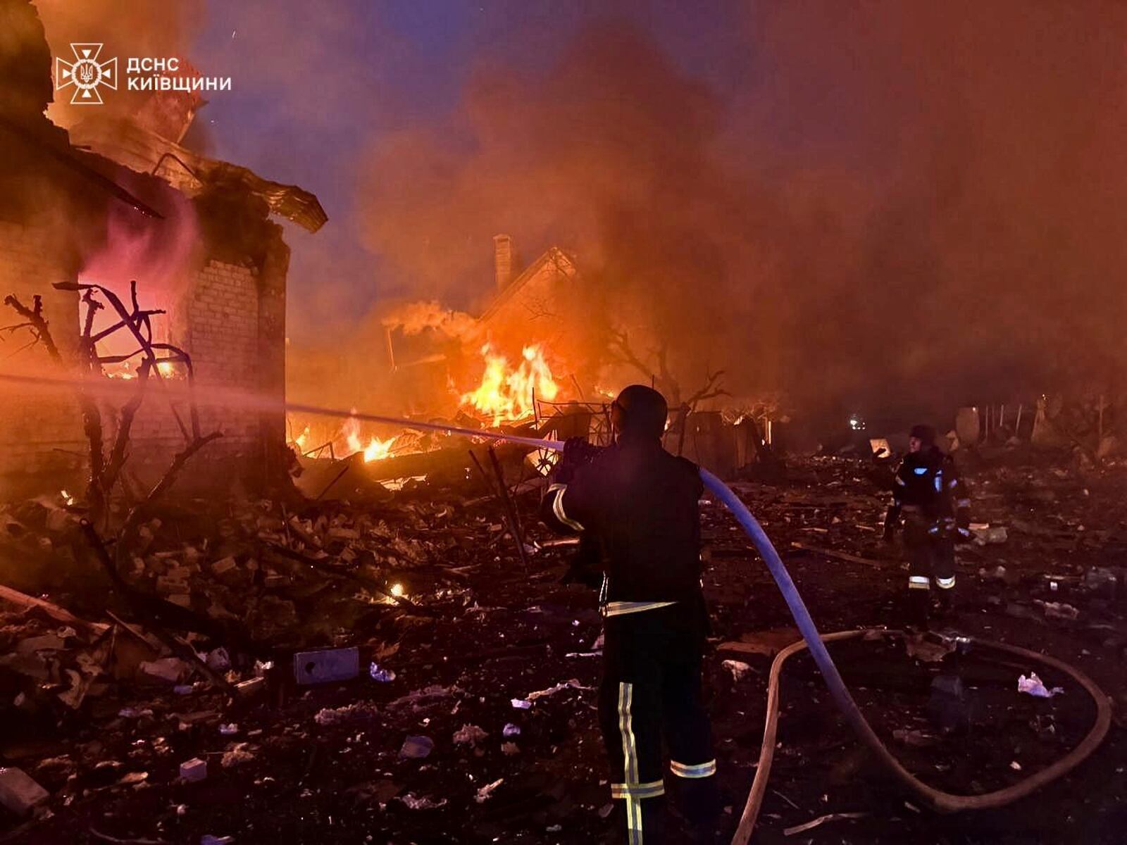 In this photo provided by the Ukrainian Emergency Service, firefighters try to put out a fire following a Russian attack in Kyiv region, Ukraine, Sunday, May 25, 2025. (Ukrainian Emergency Service via AP)