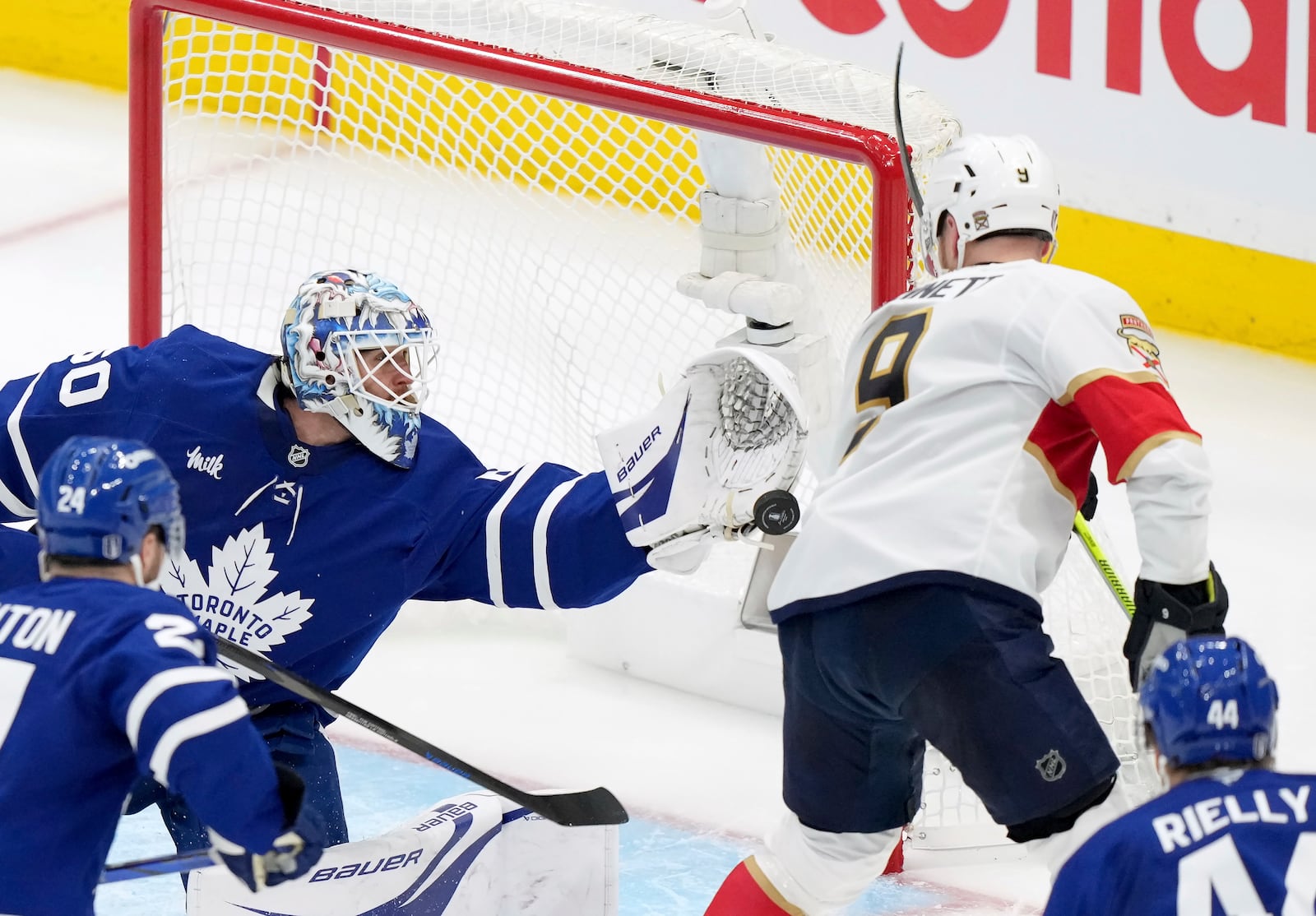 Toronto Maple Leafs goaltender Joseph Woll (60) makes a save against Florida Panthers' Sam Bennett (9) during the third period of an NHL hockey playoff game in Toronto on Wednesday, May 7, 2025. (Nathan Denette/The Canadian Press via AP)