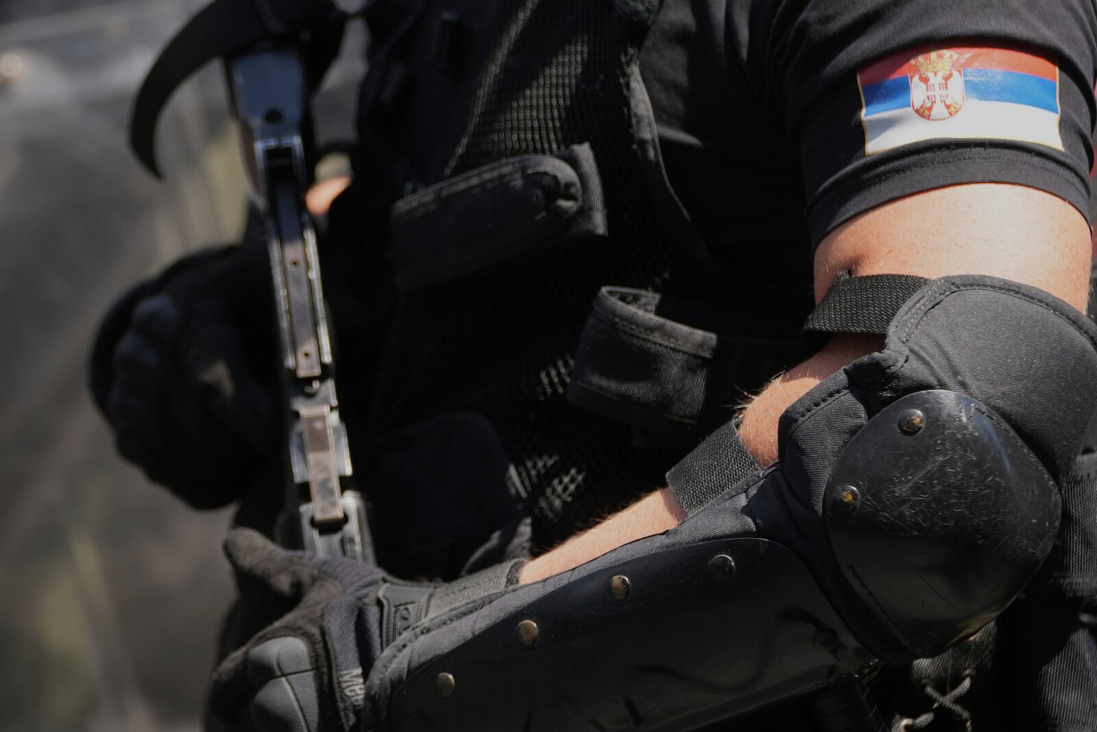 Serbian gendarmerie officers prepare to remove a street blockade that was set up as part of a protest over a spate of arrests of anti-government protesters after a massive rally demanding an early parliamentary election in Belgrade, Serbia, Monday, June 30, 2025. (AP Photo/Darko Vojinovic)