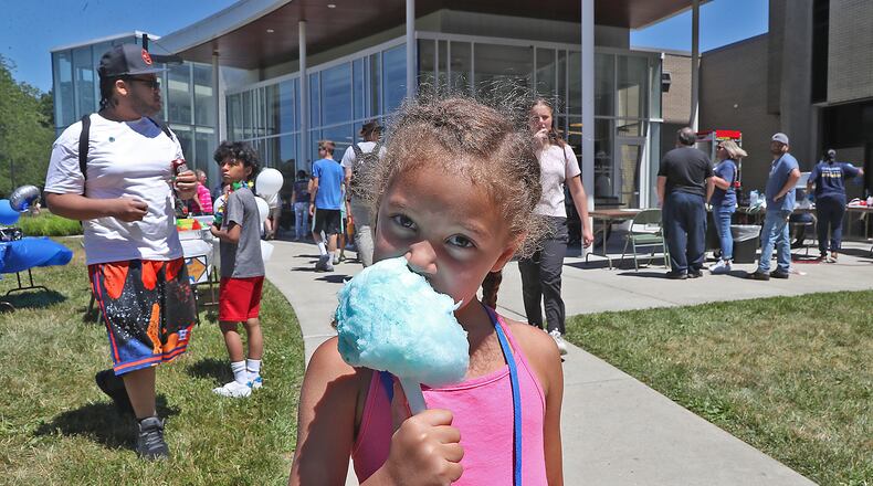 Lennix Watkins enjoys some cotton candy at Clark State College's 60th Anniversary Celebration Thursday, June 30, 2022. BILL LACKEY/STAFF