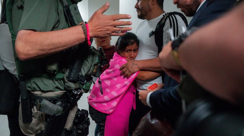 FILE - An asylum seeker from Ecuador hugs her father as he is detained by federal agents, July 31, 2025, in New York. (AP Photo/Olga Fedorova, file)