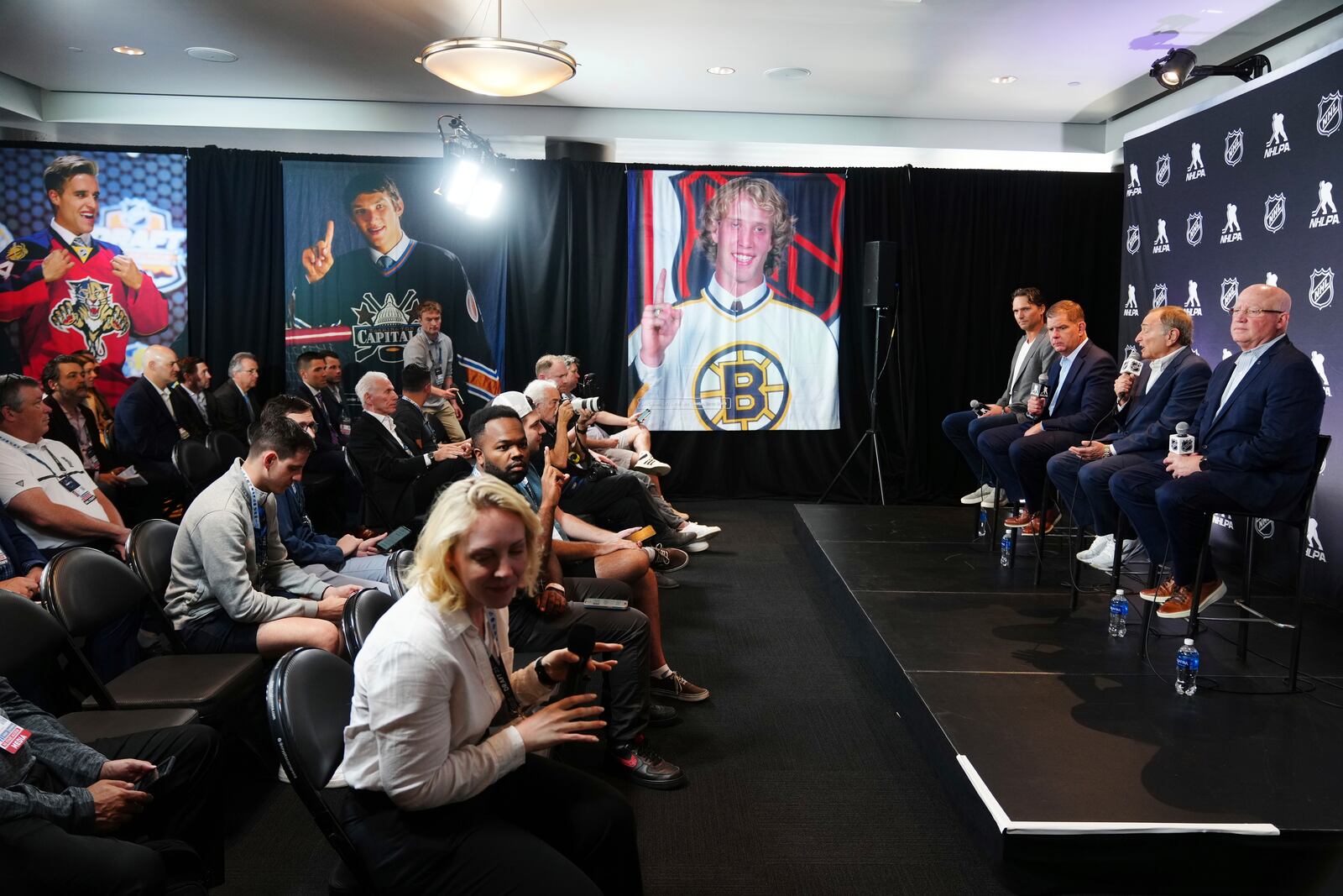 On stage from left to right, Ron Hainsey, NHLPA Assistant Executive Director; Marty Walsh, NHLPA Executive Director; Gary Bettman, NHL Commissioner, and Bill Daly, NHL Deputy Commissioner, conduct a joint press conference before the NHL hockey draft Friday, June 27, 2025, in Los Angeles. (AP Photo/Damian Dovarganes)