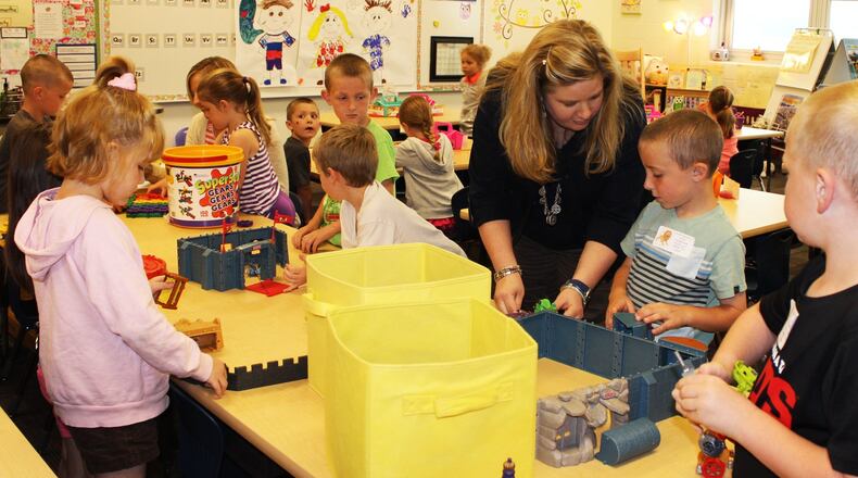 Northwestern Elementary kindergarten teacher Lauri McCutcheon helps students with a class project a few years ago. FILE