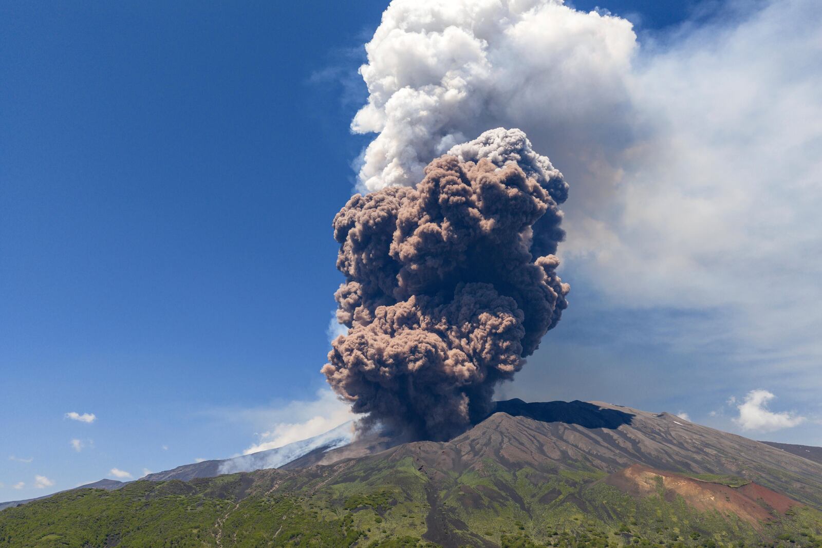 Smoke billows from Mount Etna volcano, Italy, Monday, June 2, 2025. (AP Photo/Giuseppe Distefano)