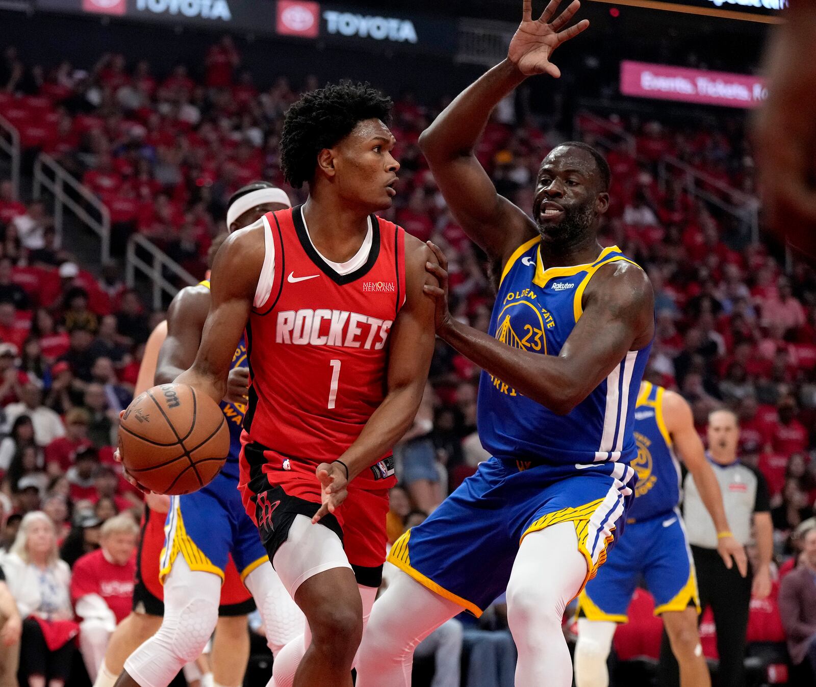 Golden State Warriors forward Draymond Green (23) defends against Houston Rockets guard Amen Thompson (1) during the first half of Game 2 of an NBA basketball first-round playoff series against the Houston Rockets in Houston, Wednesday, April 23, 2025. (AP Photo/Karen Warren)