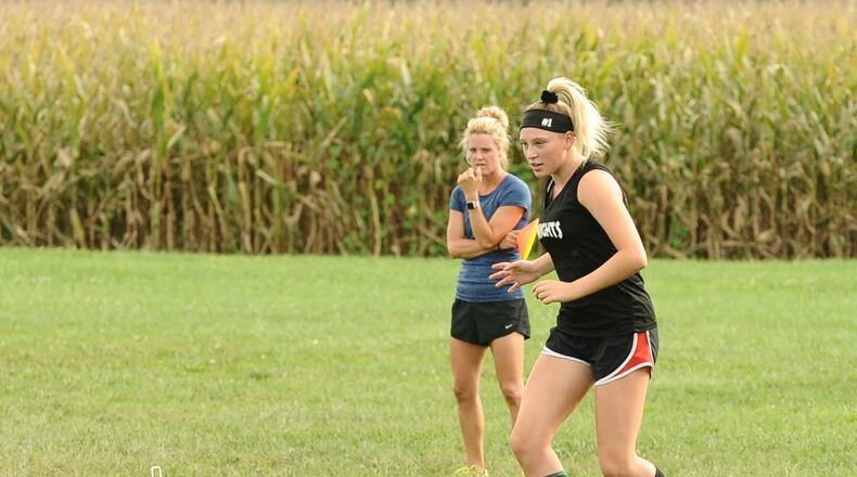 Greenon’s Emma Cramblett, who leads the Knights with 11 goals, practice her ball handling skills as coach Jamie Wiggins watches. Contributed / Greg Billing