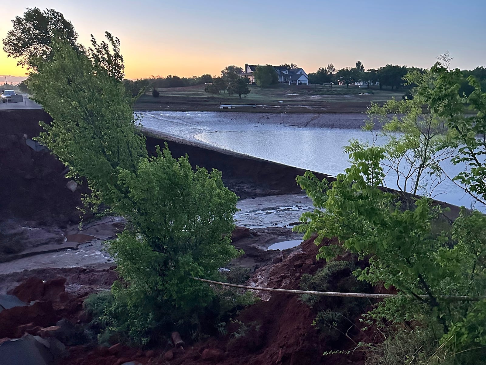 A washed-out roadway from flash-flooding is seen in Grady County, Okla., on Thursday, May 1, 2025, that left about 10 families stranded in their homes. (John Teas via AP)