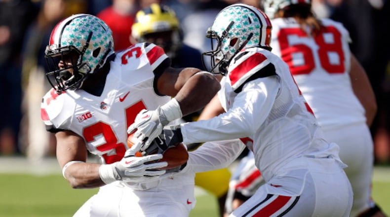 ANN ARBOR, MI - NOVEMBER 30: Quarterback Braxton Miller #5 hands the ball off to running back Carlos Hyde #34 of the Ohio State Buckeyes against the Michigan Wolverines during a game at Michigan Stadium on November 30, 2013 in Ann Arbor, Michigan. (Photo by Gregory Shamus/Getty Images)