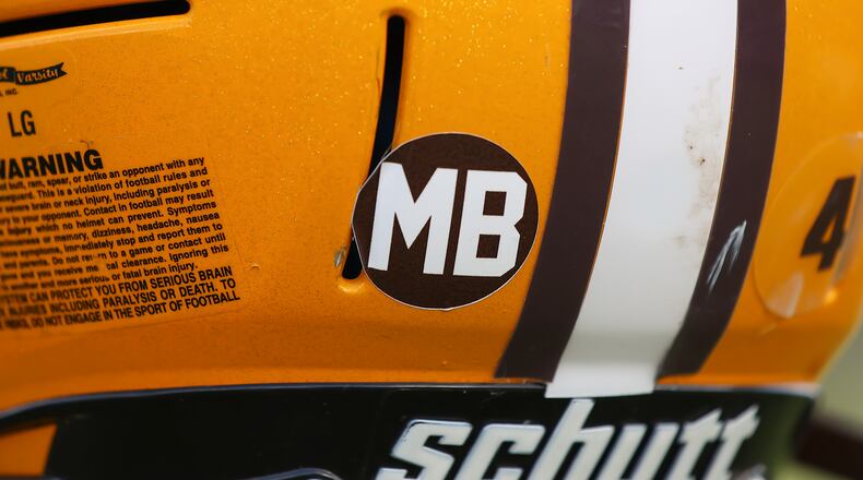 The Kenton Ridge High School football program is honoring fallen assistant coach Mike Berry with a decal on the back of their helmets. CONTRIBUTED PHOTO BY MICHAEL COOPER