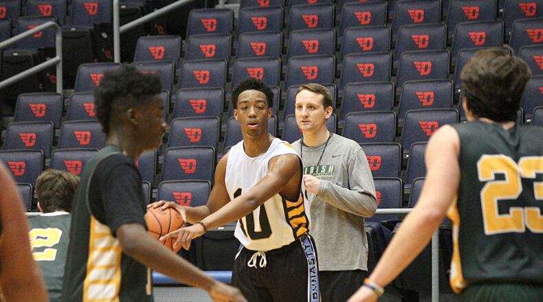 Catholic Central junior Sabien Doolittle (10) sets up a play as coach Cody Sarensen watches during practice at the University of Dayton Arena on Tuesday. Catholic Central plays Ripley-Union in the Division IV district final Friday at UD. Greg Billing / Contributed
