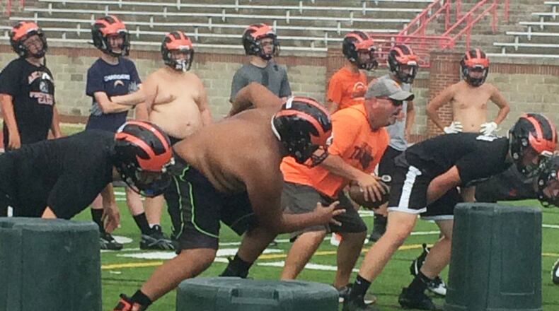 Jason Schondelmyer (with ball) is in his second season as Arcanum’s football coach. CONTRIBUTED PHOTO