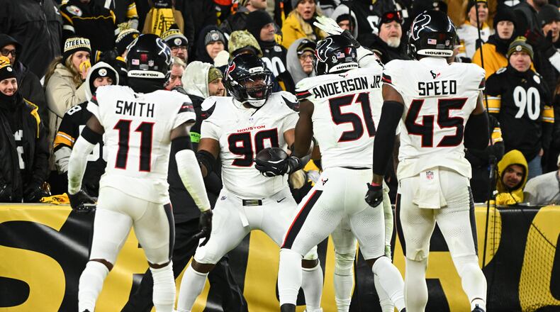 Houston Texans defensive tackle Sheldon Rankins (90) celebrates with cornerback Tremon Smith (11), defensive end Will Anderson Jr. (51) and linebacker E.J. Speed (45) after a touchdown during the second half of an NFL wild-card playoff football game against the Pittsburgh Steelers, Monday, Jan. 12, 2026, in Pittsburgh. (AP Photo/Justin Berl)