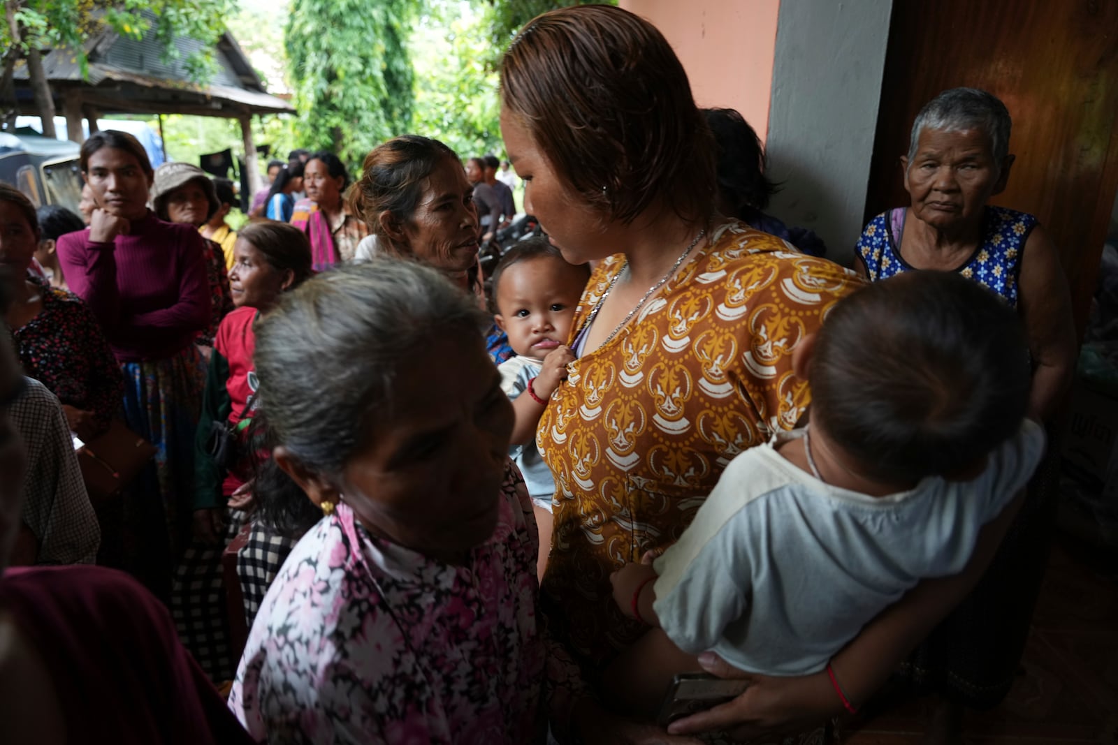 Local villagers wait to receive supplies donated by a charity, in Srey Snam district, Siem Reap province, Cambodia, Monday, July 28, 2025, amid the fighting between Thailand and Cambodia. (AP Photo/Heng Sinith)