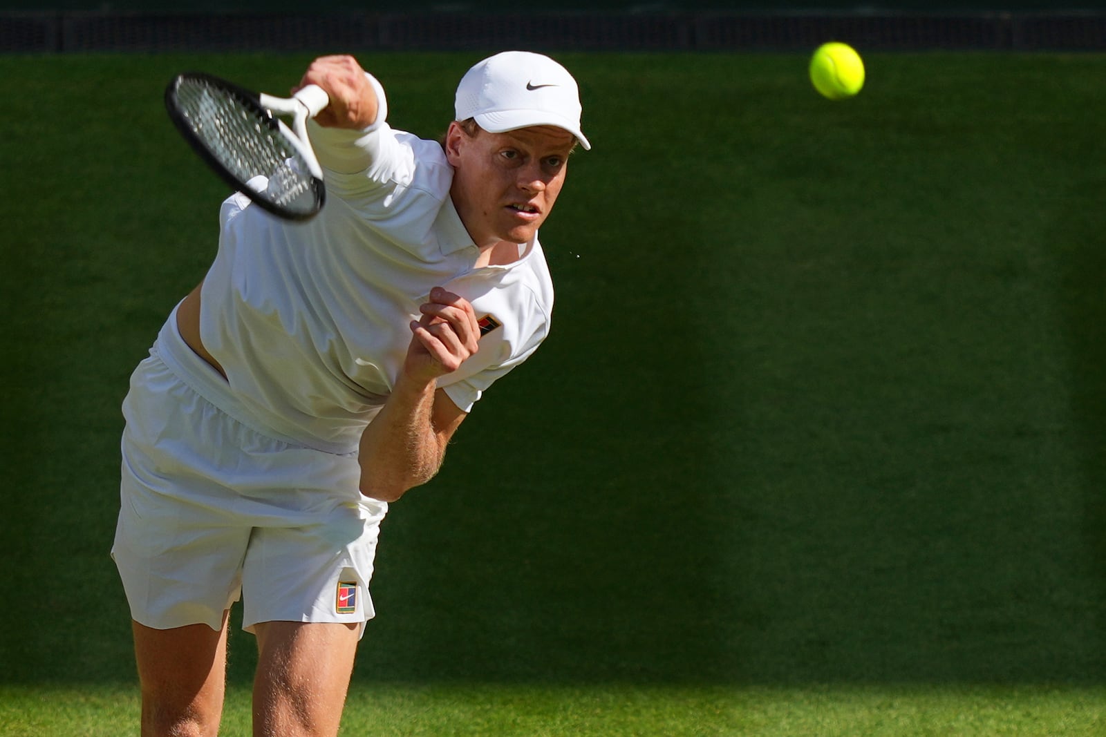 Italy's Jannik Sinner serves to Carlos Alcaraz of Spain in the men's singles final at the Wimbledon Tennis Championships in London, Sunday, July 13, 2025. (AP Photo/Joanna Chan)