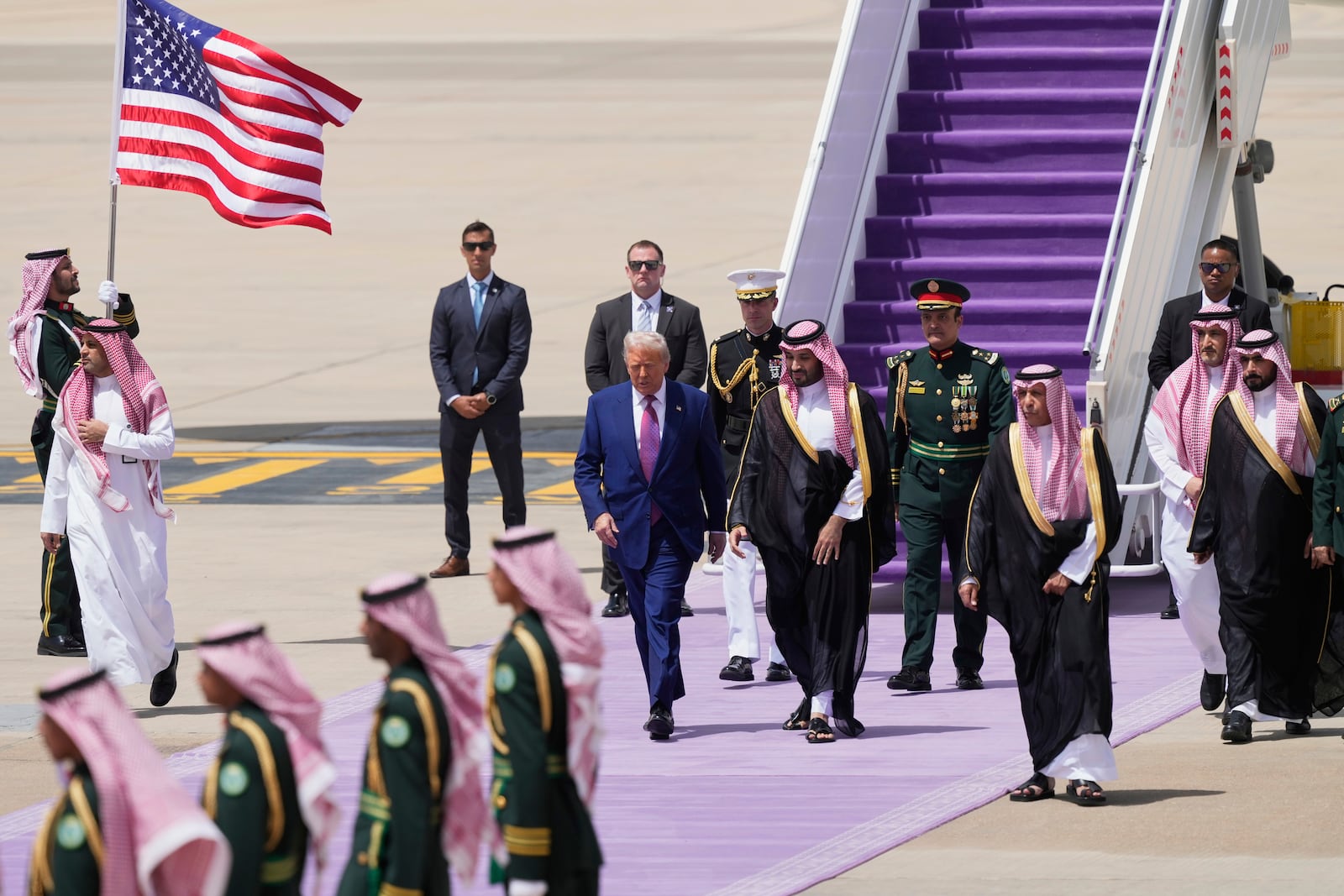 President Donald Trump walks with Saudi Crown Prince Mohammed bin Salman during an arrival ceremony at the Royal Terminal of King Khalid International Airport in Riyadh, Saudi Arabia, Tuesday, May 13, 2025