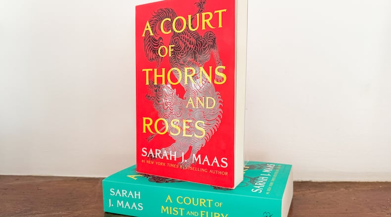 "A Court of Thorns and Roses," top, and "A Court of Mist and Fury," the first two books in author Sarah J. Maas' A Court of Thorns and Roses series are shown on a shelf in Los Angeles on Friday, March 6, 2025. (AP Photo/Anthony McCartney