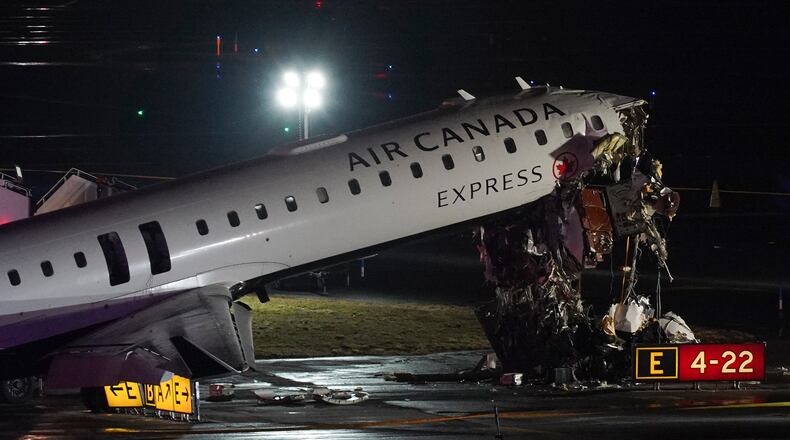 An Air Canada Jet sits on the runway at LaGuardia Airport, Monday, March 23, 2026, after colliding with a Port Authority aircraft rescue and firefighting vehicle after landing in New York. (AP Photo/Ryan Murphy)