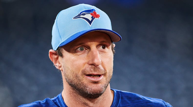 FILE - Toronto Blue Jays' Max Scherzer (31) looks on before batting practice Saturday, Oct. 18, 2025, in Toronto, a day ahead of Game 6 in baseball's American League Championship Series against the Seattle Mariners. (Sammy Kogan/The Canadian Press via AP, File)