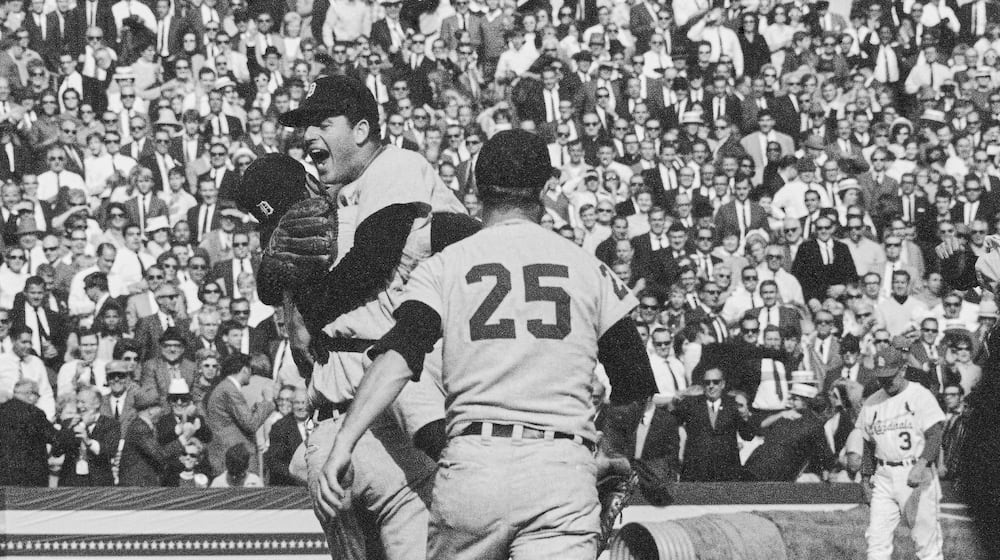 Detroit Tigers catcher Bill Freehan and pitcher Mickey Lolich off his feet as he screams with joy, after defeating the St. Louis Cardinals 4-1 in the final game of the World Series on Wednesday, Oct. 10, 1968 at Busch Stadium in St. Louis. Joining the celebration is Norm Cash (25). Lolich became the twelfth pitcher to win three games in the World Series. (AP Photo)