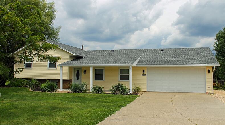 This 4-bedroom, tri-level home sits on over an acre. It includes a 2-car garage and a family room in the lower level. CONTRIBUTED PHOTO BY VICKIE KAPNAS