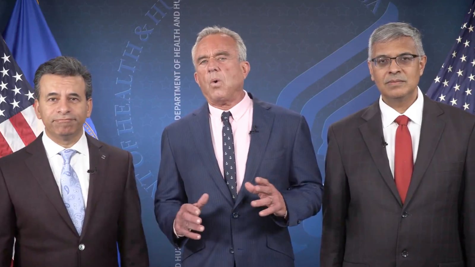 This image from video provided by the Department of Health and Human Services shows Health and Human Services Secretary Robert F. Kennedy Jr. speaking alongside Food and Drug Administration administrator Dr. Martin Makary, left, and Dr. Jay Bhattacharya, director of the National Institutes of Health, as they announce that the government would no longer endorse the COVID-19 vaccine for healthy children or pregnant women. (Health and Human Services via AP)