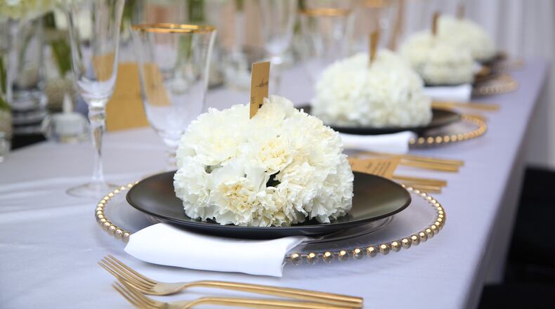 New caption: Many wedding vendors are expecting a busy 2022, boosted by people who postponed in the prior years. Pictured is a table set up in the Dayton Arcade, which has two spaces for rental, The Rotunda and on the lower level, The Tank. LISA POWELL / STAFF
Old caption: Area wedding and event vendors decorated the Dayton Arcade to display what the space looks like transformed for special events. Dayton Arcade Events, now booking for 2021 and 2022, offers two spaces for rental, The Rotunda and on the lower level, The Tank. Both spaces offer professional lighting and AV capabilities. Culture Works is the event management organization and proceeds from event rentals will be used to create a new revenue stream providing additional funding and opportunities for local arts organizations. More information about Dayton Arcade Events rental can be found on its Facebook and Instagram page @DaytonArcadeEvents and at cultureworks.org/dayton-arcade/.  LISA POWELL / STAFF