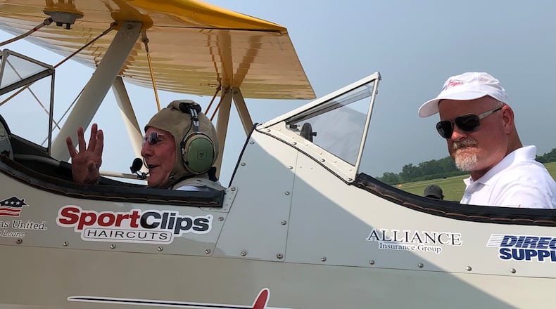 Don Muncy, left, gets set to take a flight in a restored 1942 Boeing Stearman biplane with Dream Flights founder and pilot Darryl Fisher on Tuesday at Grimes Field Airport in Urbana. Muncy, age 100, served in the U.S. Navy during World War II and the Korean War.