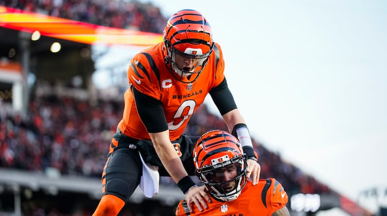 Cincinnati Bengals wide receiver Tee Higgins (85) and quarterback Joe Burrow (9) celebrate a touchdown against the Kansas City Chiefs in the first half of an NFL football game in Cincinnati, Sunday, Dec. 4, 2022. (AP Photo/Joshua Bickel)