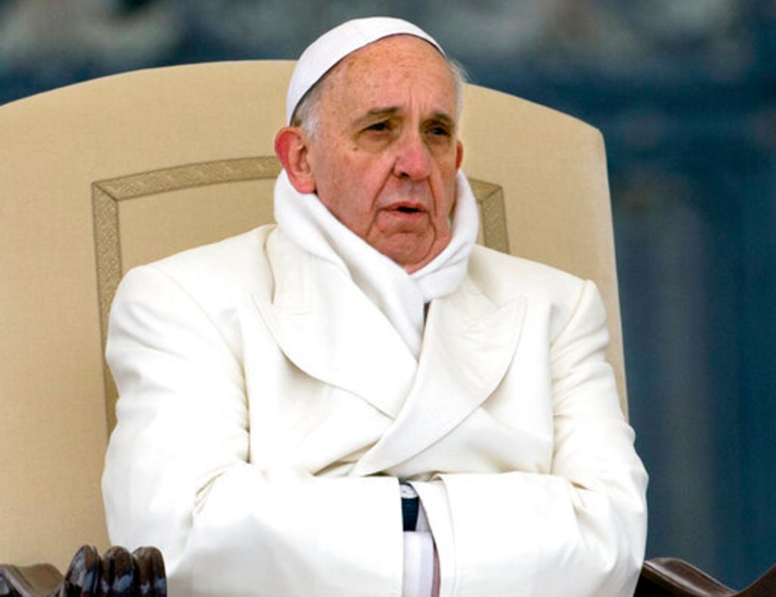 FILE - Pope Francis tries to keep himself warm as he attends his weekly general audience in St. Peter's Square at the Vatican, Wednesday, Nov. 27, 2013. (AP Photo/Alessandra Tarantino, File )