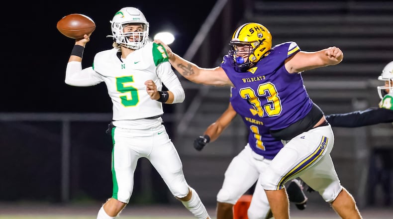 Springfield High School senior Preston Allen reaches out to tackle Northmont senior quarterback Bryce Staggs as the Wildcats beat Northmont 56-7 on Friday, Oct. 24 at Wildcat Stadium. MICHAEL COOPER / STAFF PHOTO
