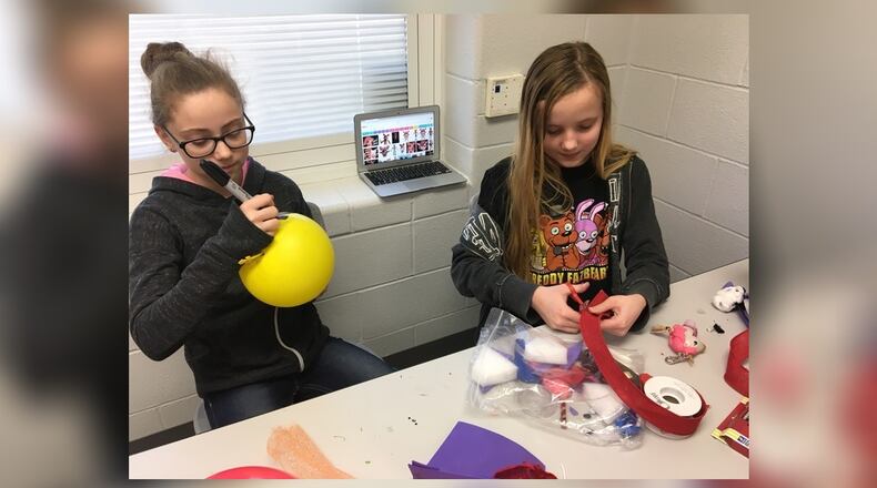Simon Kenton Elementary sixth grade students Kylee Wilson and Mandy Henry create items based on the popular video game, “Five Nights at Freddy’s,” to sell at a Market Day event on Tuesday. Photo by Brett Turner