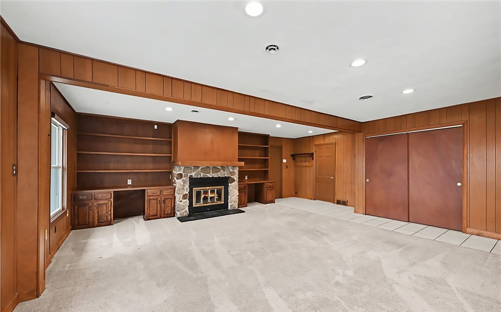The family room has updated carpeting, recessed lighting, a wood burning stone fireplace and built in bookcases. CONTRIBUTED