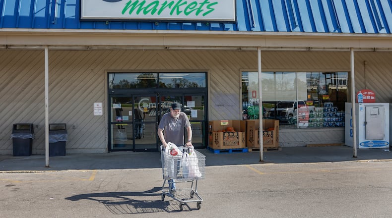A shopper leaves Community Markets on Friday, October 17, 2025 in Park Layne. The store announced it's closing soon. JOSEPH COOKE/STAFF