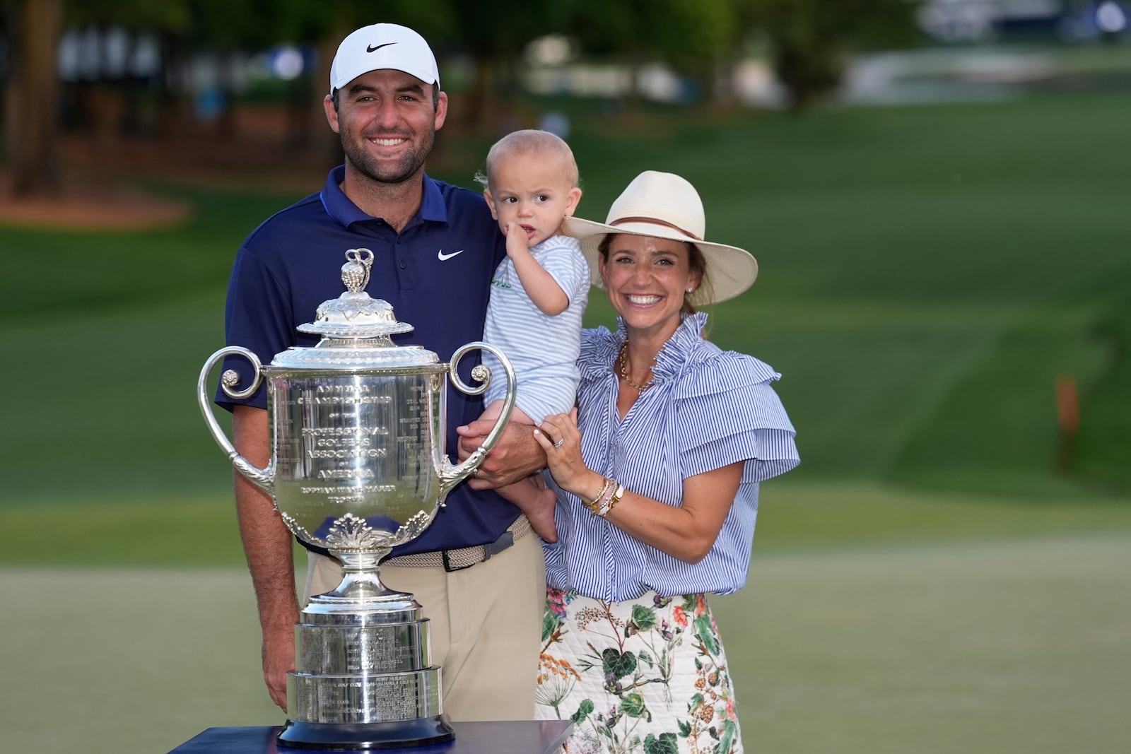 Scottie Scheffler, wife Meredith pose with their son Bennett after winning the PGA Championship golf tournament at the Quail Hollow Club, Sunday, May 18, 2025, in Charlotte, N.C. (AP Photo/David J. Phillip)
