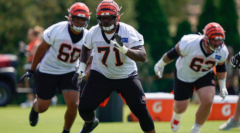 Cincinnati Bengals tackle Andre Smith (71) runs a drill during NFL football training camp, Sunday, July 28, 2019, in Cincinnati. (AP Photo/Bryan Woolston)