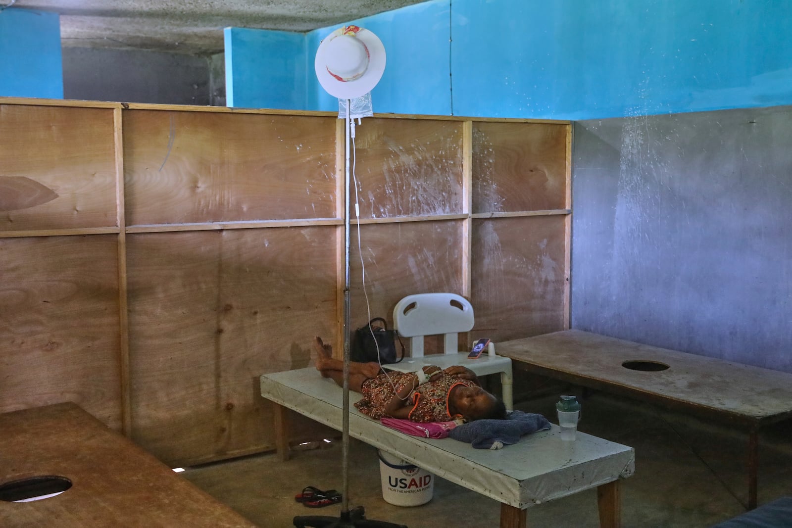 A patient with cholera symptoms receives serum on a bed at the Fontaine Hospital Center in the Cite Soleil neighborhood of Port-au-Prince, Haiti, Tuesday, May 20, 2025. USAID supplies can be seen in the room, but the Trump administration has made cuts to that program as well. (AP Photo/Odelyn Joseph)
