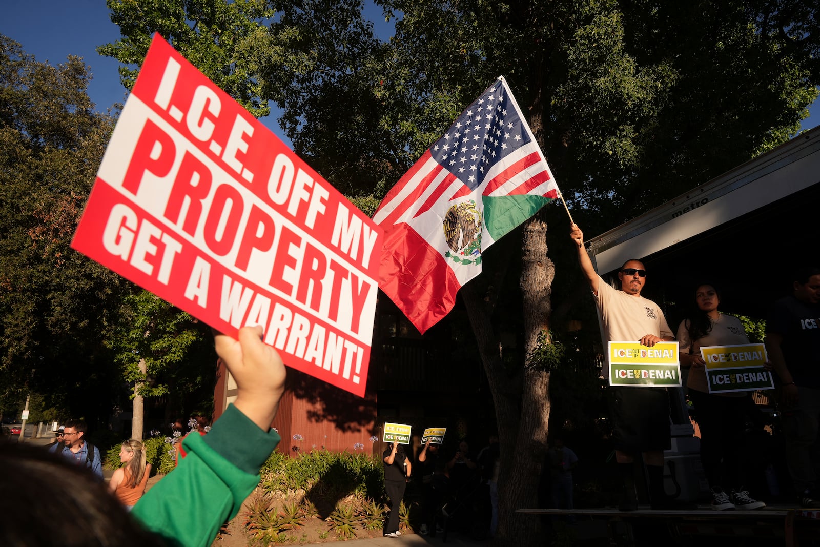 Residents gather during a community vigil on Monday, June 30, 2025, to stand in solidarity with an immigrant family after ICE agents detained Rosalina Luna Vargas on Saturday, June 28, in front of her children, in Pasadena, Calif. (AP Photo/Damian Dovarganes)