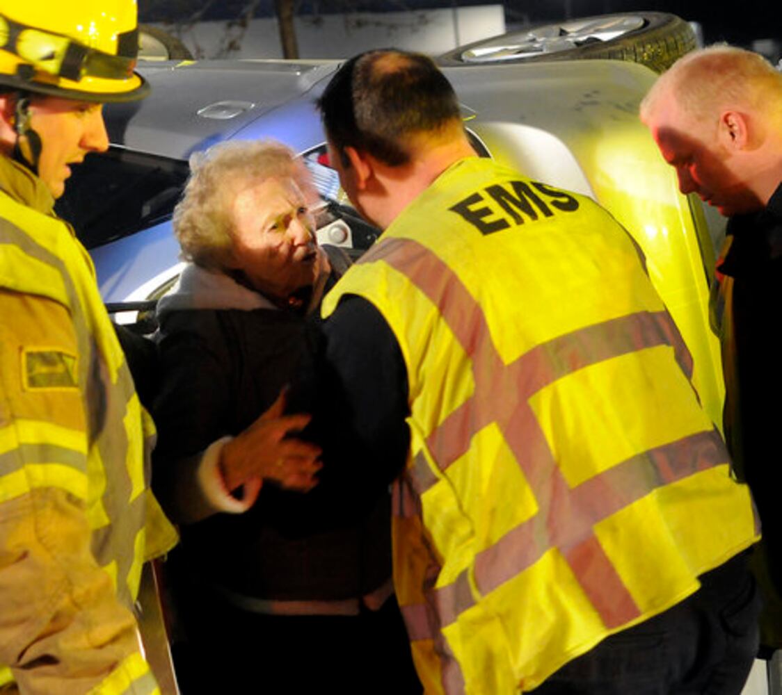 Car hits fire hydrant, turns on side