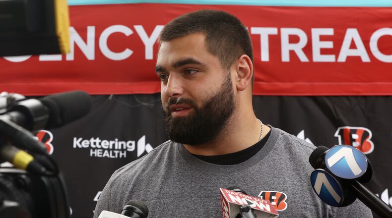 Bengals third-round pick Dylan Fairchild talks to reporters at an NFL Flag In-School event that featured Bengals rookies at the Dayton Early College Academy PREP on Friday, May 16, 2025, in Dayton. In the background is third-round pick Dylan Fairchild. David Jablonski/Staff