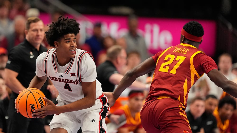 Texas Tech's Christian Anderson (4) looks to pass round Iowa State's Killyan Toure (27) during the first half of an NCAA college basketball game in the quarterfinal round of the Big 12 Conference tournament Thursday, March 12, 2026, in Kansas City, Mo. (AP Photo/Charlie Riedel)